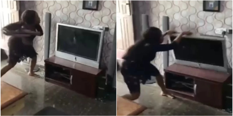 Nigerian lady destroys boyfriend's TV in anger over alleged affair