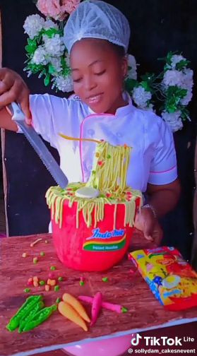 "Agba Baker" – Lady stirs up reactions as she shows off mind-blowing indomie cake (Video)