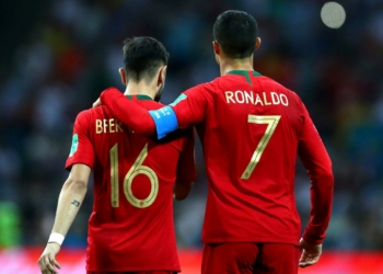 SOCHI, RUSSIA - JUNE 15:  Cristiano Ronaldo of Portugal embraces team mate Bruno Fernandes  during the 2018 FIFA World Cup Russia group B match between Portugal and Spain at Fisht Stadium on June 15, 2018 in Sochi, Russia.  (Photo by Dean Mouhtaropoulos/Getty Images)