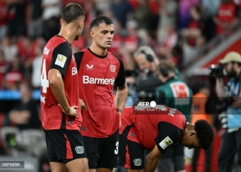 Bayer Leverkusen's Swiss midfielder #34 Granit Xhaka (C) and his teammates react after the German first division Bundesliga football match between Bayer 04 Leverkusen and RB Leipzig in Leverkusen, southwestern Germany on August 31, 2024. (Photo by UWE KRAFT / AFP) / DFL REGULATIONS PROHIBIT ANY USE OF PHOTOGRAPHS AS IMAGE SEQUENCES AND/OR QUASI-VIDEO