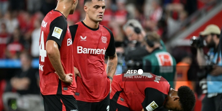 Bayer Leverkusen's Swiss midfielder #34 Granit Xhaka (C) and his teammates react after the German first division Bundesliga football match between Bayer 04 Leverkusen and RB Leipzig in Leverkusen, southwestern Germany on August 31, 2024. (Photo by UWE KRAFT / AFP) / DFL REGULATIONS PROHIBIT ANY USE OF PHOTOGRAPHS AS IMAGE SEQUENCES AND/OR QUASI-VIDEO