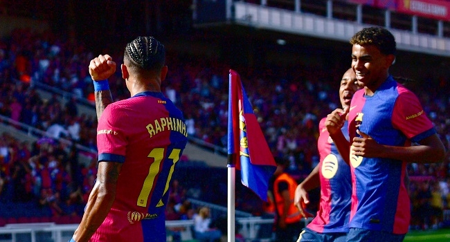 Barcelona's Brazilian forward #11 Raphinha celebrates scoring his team's first goal with Barcelona's Spanish forward #19 Lamine Yamal during the Spanish league football match between FC Barcelona and Real Valladolid FC at the Estadi Olimpic Lluis Companys in Barcelona on August 31, 2024. (Photo by MANU QUINTERO / AFP)