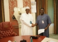 President Buhari and his Special Adviser, Femi Adesina, exchanging pleasantries