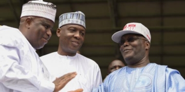 Former Nigerian vice-President Atiku Abubakar (R) is congratulated by runners-up Sokoto State Governor Aminu Tambuwal (L) and Senate President Bukola Saraki (C) after winning the presidential ticket of the opposition People's Democratic Party (PDP) during the party's national convention in Port Harcourt, Rivers State on October 7, 2018. - Nigeria's main opposition Peoples Democratic Party (PDP) has picked Abubakar to challenge President Muhammadu Buhari who is seeking a second term in presidential polls scheduled for February 2019. (Photo by PIUS UTOMI EKPEI / AFP)        (Photo credit should read PIUS UTOMI EKPEI/AFP/Getty Images)