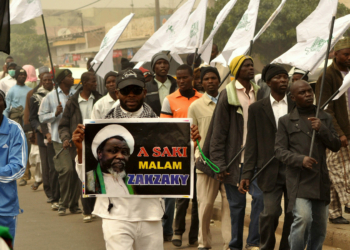 Nigeria Shiite Muslims hold religious flags and banners in a procession celebrating Prophet Muhammad’s birthday and also demanding the release of Shiite leader Ibraheem Zakzaky, on posters, in Kano, Nigeria, Thursday, Dec. 24, 2015.  The demonstration was in part provoked after a recent attack by Nigerian soldiers who fired on unarmed Islamic Shiite children with no provocation, killing some hundreds of the minority group in the West African nation, according to a report from Human Rights Watch.  (AP Photo/Muhammed Giginyu)