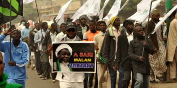 Nigeria Shiite Muslims hold religious flags and banners in a procession celebrating Prophet Muhammad’s birthday and also demanding the release of Shiite leader Ibraheem Zakzaky, on posters, in Kano, Nigeria, Thursday, Dec. 24, 2015.  The demonstration was in part provoked after a recent attack by Nigerian soldiers who fired on unarmed Islamic Shiite children with no provocation, killing some hundreds of the minority group in the West African nation, according to a report from Human Rights Watch.  (AP Photo/Muhammed Giginyu)