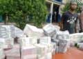 Seized Naira notes, Ilicit currency trader arrested in Edo State