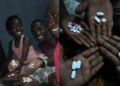 HIV positive family members show off medication they take daily