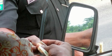 Nigerian Policeman collecting bribe