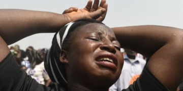 A woman cries during a funeral service