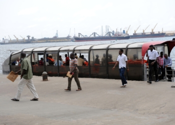 Passengers alight from a ferry in Lagos. Photographer: Pius Utomi Ekpei/AFP/