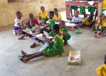 pupils sit on floor to learn