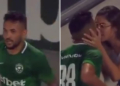 a Brazilian footballer kissing his wife after 'scoring' a goal