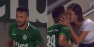 a Brazilian footballer kissing his wife after 'scoring' a goal