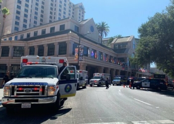 Fire crews gather on Market Street outside the Hotel Fairmont in downtown San Jose, Calif., after a report of a chemical odor Saturday, Aug. 31, 2019. Authorities say at least one woman has died and several people have been sickened in a hazmat incident Saturday at the Northern California hotel. (Nico Savidge/San Jose Mercury News via AP)