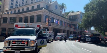 Fire crews gather on Market Street outside the Hotel Fairmont in downtown San Jose, Calif., after a report of a chemical odor Saturday, Aug. 31, 2019. Authorities say at least one woman has died and several people have been sickened in a hazmat incident Saturday at the Northern California hotel. (Nico Savidge/San Jose Mercury News via AP)