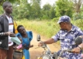 Woman kneels down begging police officers not to confiscate motorcycle of a rider carrying sick child