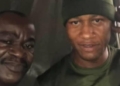 PHOTOS: Soldier appreciated by Nigerian man after helping him to repair his faulty car in the rain