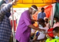 Pastor Enoch Adeboye laying hands on the sick